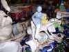 White statue amid a clutter of colorful objects