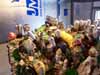 Cluttered, multicolored wall or building densely covered with folk-art decorations