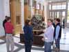 Several people standing in a room around a large decorative object