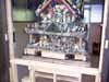 A blurry small multi-story house model on a wooden stand