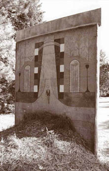 Concrete wall with painted mural of archway and small figure