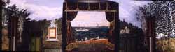 Painted wooden archway framing a landscape backdrop with trees on both sides