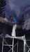 A blurry white figure on a dark platform structure