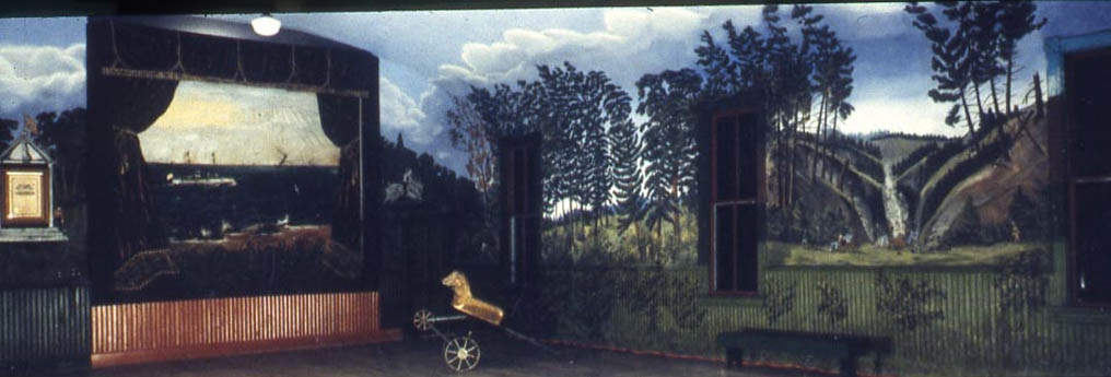 Painted mural of forest landscape with waterfall, stage opening, and golden dog figure