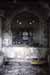 Blurry dark stone wall with an arched window opening