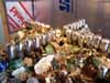 Blurry table covered with many small figurines and a flag in background