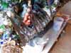A blurry colorful sculptural figure in a folk-art setting